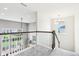 An open loft space with a stylish modern chandelier overlooks the well-lit downstairs at 3645 Conifer Dr, Zionsville, IN 46077