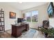 Inviting home office with a dark wood desk and a view of the exterior from a bright, sunny window at 3645 Conifer Dr, Zionsville, IN 46077