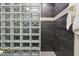 Stylish glass block shower with sleek gray tiles and decorative accents for a luxurious feel at 3645 Conifer Dr, Zionsville, IN 46077