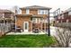 Spacious backyard with green lawn, grill, patio dining, and a basketball court at 3652 N Delaware St, Indianapolis, IN 46205