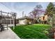 The backyard is spacious with a detached garage, lovely green grass, and mature trees at 3652 N Delaware St, Indianapolis, IN 46205