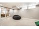 Spacious finished basement has a sliding door, windows, and a large beanbag chair at 3652 N Delaware St, Indianapolis, IN 46205