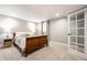 Finished basement bedroom with a bed, window, and a white paneled door at 3652 N Delaware St, Indianapolis, IN 46205