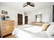 Bright bedroom features hardwood floors, wood trim, ceiling fan and light wood furniture at 3652 N Delaware St, Indianapolis, IN 46205
