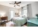 Bedroom with a desk, bed, large window, area rug and light-colored walls at 3652 N Delaware St, Indianapolis, IN 46205