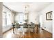 Sunlit dining room featuring a modern chandelier and large windows adorned with patterned curtains at 3652 N Delaware St, Indianapolis, IN 46205