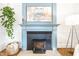 Close up of fireplace with dark wood burning insert and a decorative blue mantle at 3652 N Delaware St, Indianapolis, IN 46205