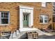 Charming front entrance with a green door, concrete steps, and brick siding at 3652 N Delaware St, Indianapolis, IN 46205