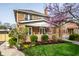 Beautiful brick home with a welcoming front porch and professionally landscaped yard with mature bushes at 3652 N Delaware St, Indianapolis, IN 46205