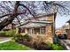 Brick home with a cozy front porch and a driveway leading to a detached garage at 3652 N Delaware St, Indianapolis, IN 46205