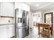 Modern kitchen featuring stainless steel appliances, white cabinets, and a wooden island on a stylish floor at 3652 N Delaware St, Indianapolis, IN 46205