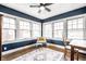 Bright living room with three windows, blue walls, hardwood floors, and a decorative rug at 3652 N Delaware St, Indianapolis, IN 46205