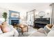 Bright living room featuring a blue fireplace, a piano, and neutral furnishings at 3652 N Delaware St, Indianapolis, IN 46205