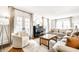 Open living room with a piano, and french doors leading to an outdoor area at 3652 N Delaware St, Indianapolis, IN 46205