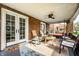 Covered front porch featuring comfortable seating, a ceiling fan, and brick pillars at 3652 N Delaware St, Indianapolis, IN 46205