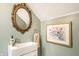 Stylish powder room with a vessel sink, decorative mirror, and green painted walls at 3652 N Delaware St, Indianapolis, IN 46205