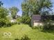 The home's backyard showing a large area of green lawn at 428 E Trevor St, Brownsburg, IN 46112