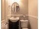 Classic bathroom with a stylish vanity, a framed mirror, and beadboard paneling at 428 E Trevor St, Brownsburg, IN 46112