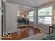 Bright bedroom boasts gleaming wood floors and mirrored closet doors for extra space at 428 E Trevor St, Brownsburg, IN 46112