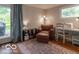 Relaxing bedroom with a cozy armchair, workspace, and natural light from a nearby window at 428 E Trevor St, Brownsburg, IN 46112