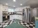 Bright kitchen featuring white cabinets, stainless appliances, and charming black-and-white checkered flooring at 428 E Trevor St, Brownsburg, IN 46112