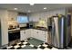 Modern kitchen with stainless steel appliances, ample cabinet space, and a stylish black and white checkered floor at 428 E Trevor St, Brownsburg, IN 46112