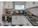 Bright kitchen featuring white cabinets, dark countertops, and stainless steel appliances at 428 E Trevor St, Brownsburg, IN 46112