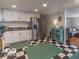 Traditional-style kitchen with white cabinets, stainless appliances, and retro black-and-white flooring at 428 E Trevor St, Brownsburg, IN 46112