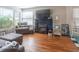 Well-lit living room features hardwood floors, mantel, and a comfortable armchair at 428 E Trevor St, Brownsburg, IN 46112