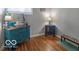 Bright room with hardwood floors features a vintage cabinet and decorative dog-themed accents at 428 E Trevor St, Brownsburg, IN 46112