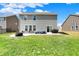 Expansive backyard with a concrete patio, hot tub, outdoor seating, grill, and lush lawn at 4345 Maize Ln, Whitestown, IN 46075