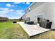 Backyard featuring a patio with grill and a hot tub, complemented by a lush green lawn at 4345 Maize Ln, Whitestown, IN 46075