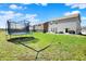 Spacious backyard with a trampoline, hammock, and lush green lawn, perfect for outdoor fun at 4345 Maize Ln, Whitestown, IN 46075