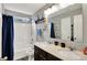 Bathroom featuring a dual sink vanity, nautical décor, and a combined shower and tub at 4345 Maize Ln, Whitestown, IN 46075