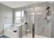 Bright bathroom featuring a glass enclosed shower with marbled tile and a soaking tub at 4345 Maize Ln, Whitestown, IN 46075
