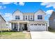 Charming two-story home with a covered porch, two-car garage, and gray siding at 4345 Maize Ln, Whitestown, IN 46075