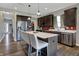 Modern kitchen featuring a central island with bar seating, stainless appliances, and dark wood cabinets at 4345 Maize Ln, Whitestown, IN 46075