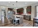 Spacious kitchen featuring dark cabinetry, stainless steel appliances, and a center island with seating at 4345 Maize Ln, Whitestown, IN 46075