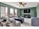 Bright living room showcases a ceiling fan, windows, a large sectional sofa, and a media center at 4345 Maize Ln, Whitestown, IN 46075