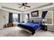 Spacious main bedroom boasts a tray ceiling, plush carpeting, and large windows with blue curtains at 4345 Maize Ln, Whitestown, IN 46075