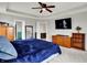 Spacious main bedroom featuring soft carpet, wooden furniture, and a ceiling fan for optimal comfort at 4345 Maize Ln, Whitestown, IN 46075