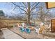 Gravel backyard featuring fire pit with seating, and a mature shade tree at 4814 Lynton Ct, Indianapolis, IN 46254