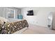 Relaxing bedroom featuring a comfortable bed, mounted TV, and a modern mirror for a stylish touch at 4814 Lynton Ct, Indianapolis, IN 46254