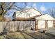 Townhouse exterior displaying fenced yard and access to two garage doors at 4814 Lynton Ct, Indianapolis, IN 46254
