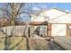Exterior shot of the property with a fenced yard, garage, and mature tree at 4814 Lynton Ct, Indianapolis, IN 46254