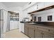 Well-lit kitchen features gray cabinets, stainless steel appliances, and a view into the adjacent laundry area at 4814 Lynton Ct, Indianapolis, IN 46254