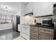 Modern kitchen with stainless steel appliances, including a stove and microwave, with white cabinets and granite countertops at 4814 Lynton Ct, Indianapolis, IN 46254