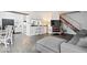 Open-concept space featuring a living area with a gray sofa, a dining area, and a kitchen with modern appliances at 4814 Lynton Ct, Indianapolis, IN 46254