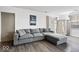 Bright living room featuring wood floors, a comfortable gray sectional, and a stylish front door and decor at 4814 Lynton Ct, Indianapolis, IN 46254
