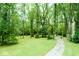 A winding walking path passes through a grassy field surrounded by mature trees at 4814 Lynton Ct, Indianapolis, IN 46254